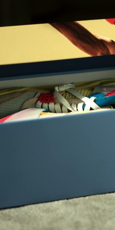 Opened shoe box revealing vibrant sneakers, perfect for fashion lovers.