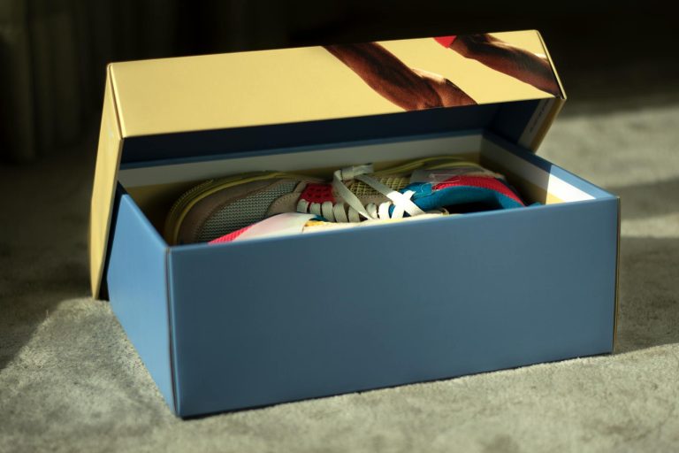 Opened shoe box revealing vibrant sneakers, perfect for fashion lovers.